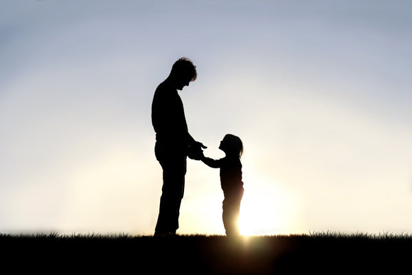 Happy Father's Day - Father with child against sunset
