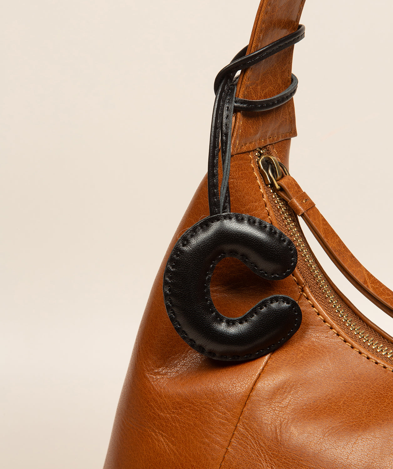 leather letter charm close-up showing letter definition