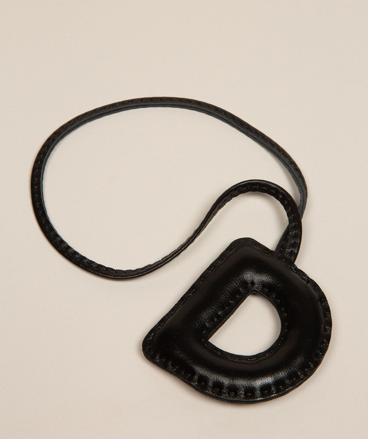 black leather letter charm with embossed D front view