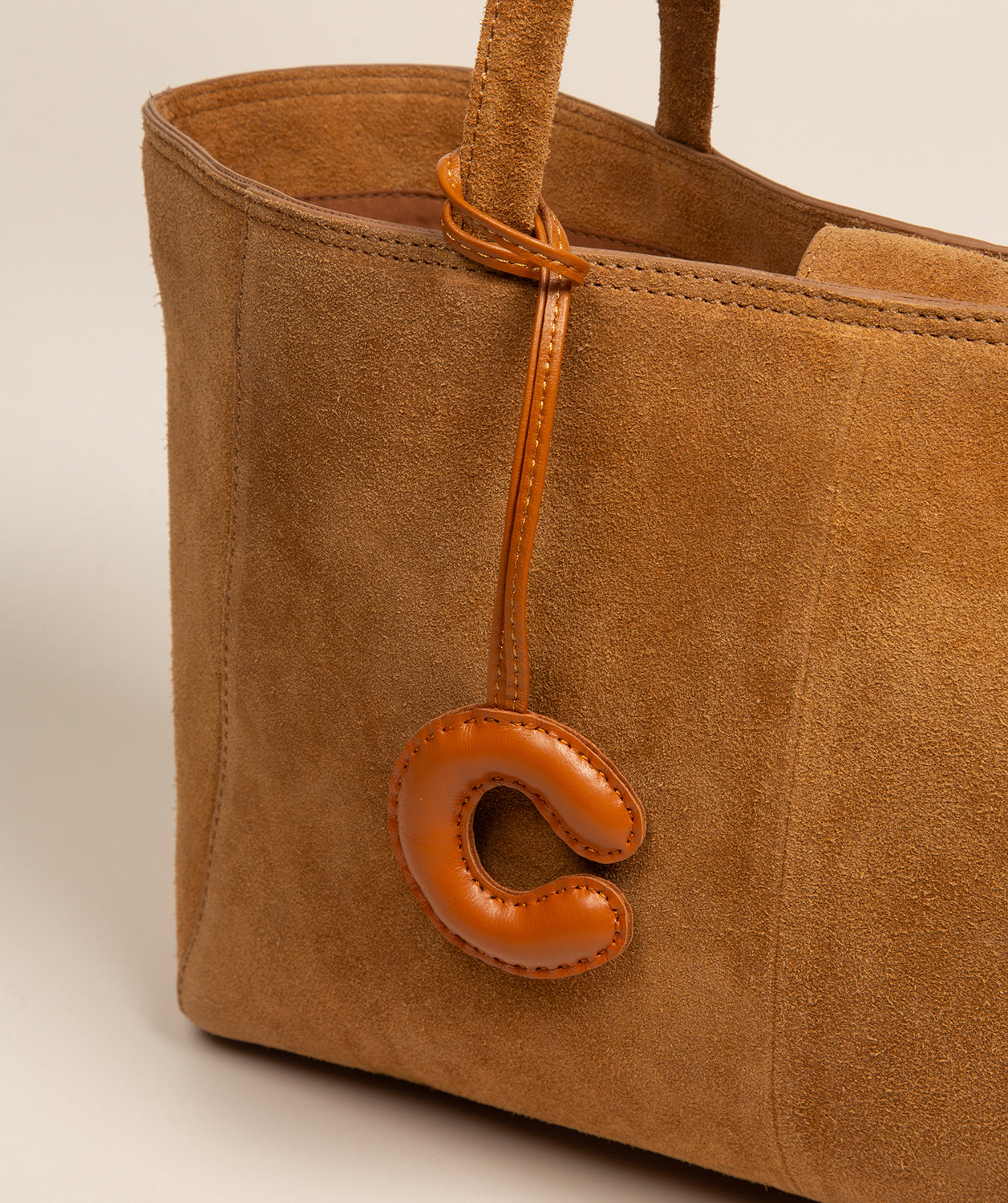 tan leather charm with natural patina finish