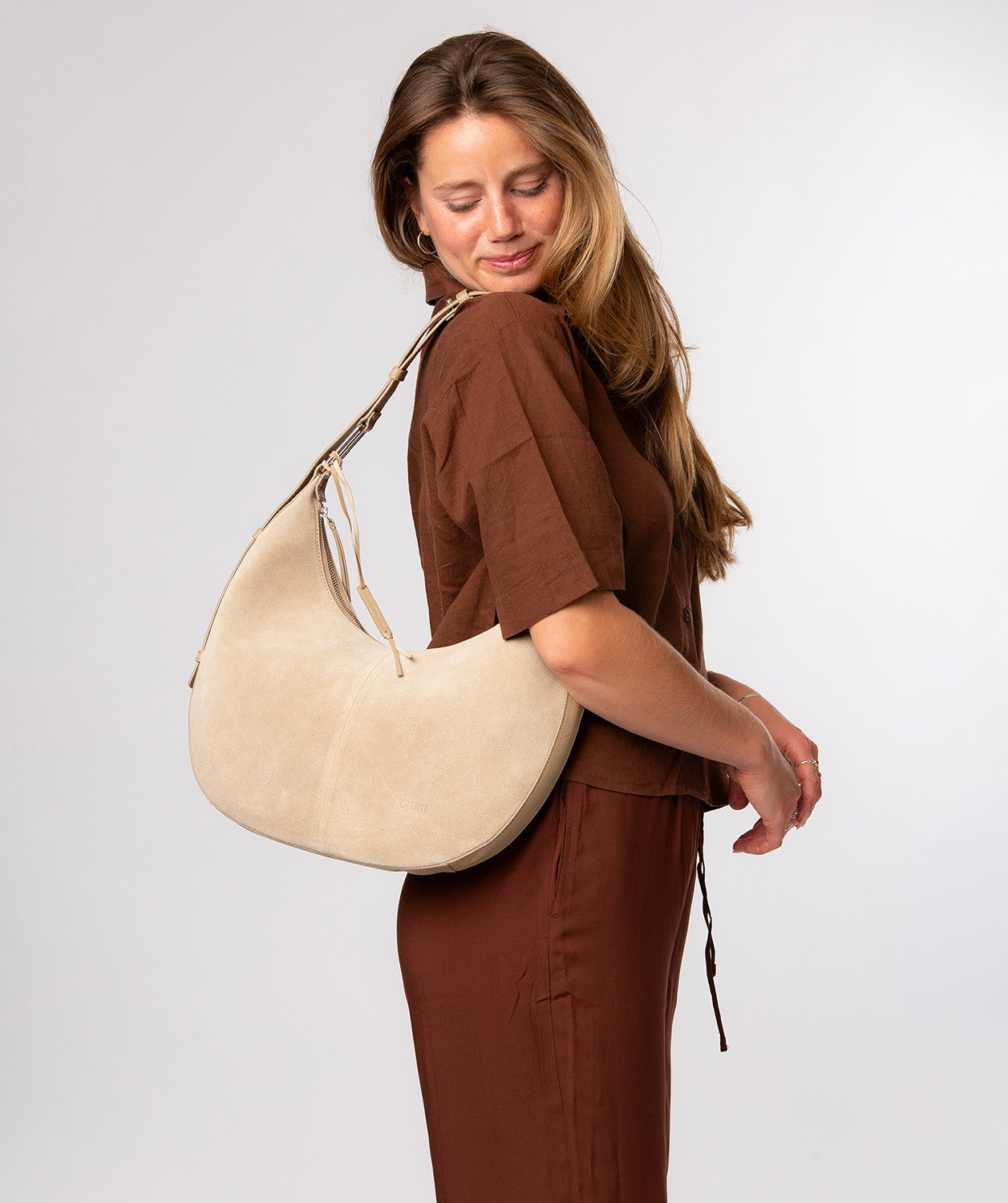 Beige suede and leather trim detail with silver hardware