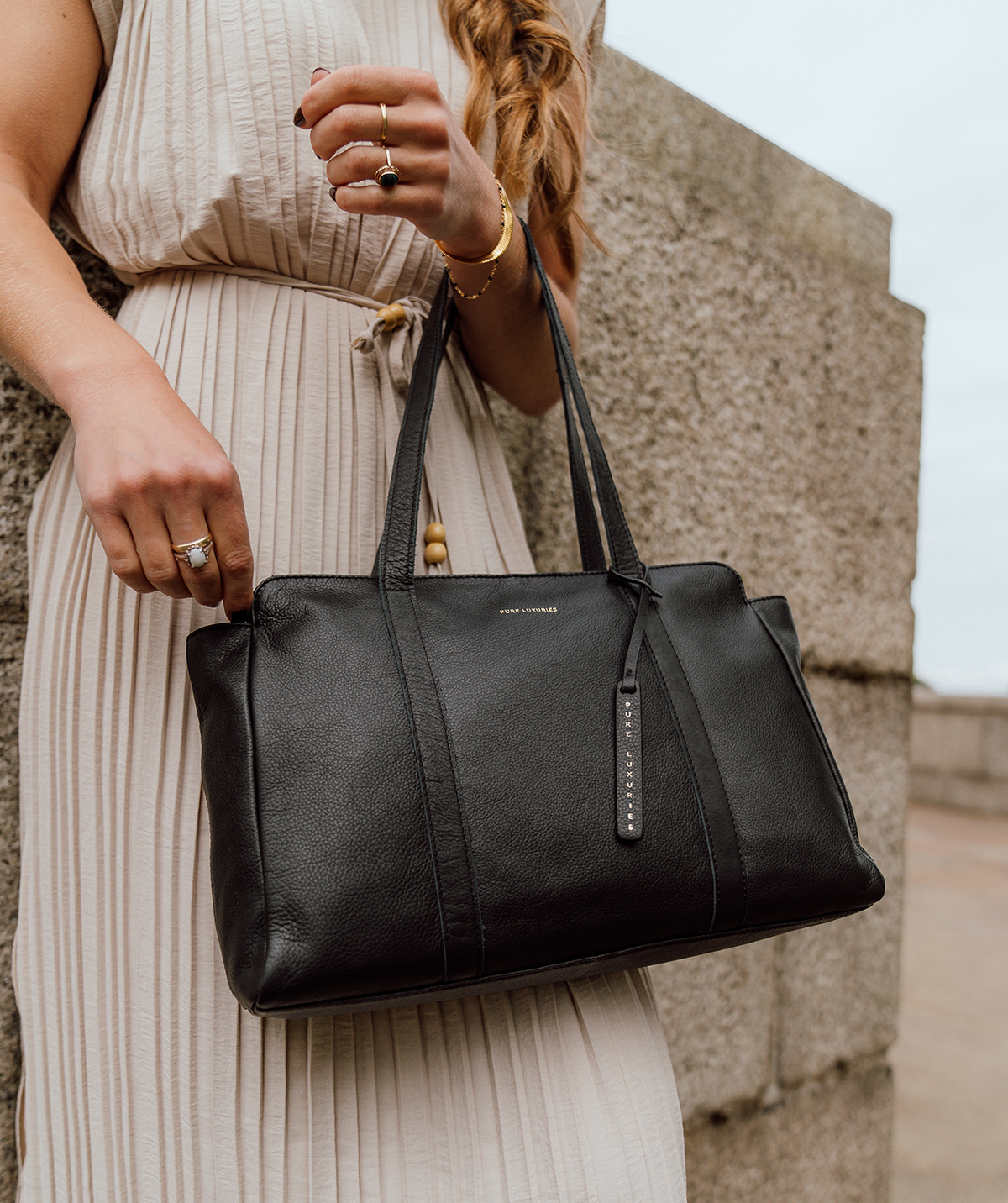 Leather handbag worn over shoulder lifestyle shot