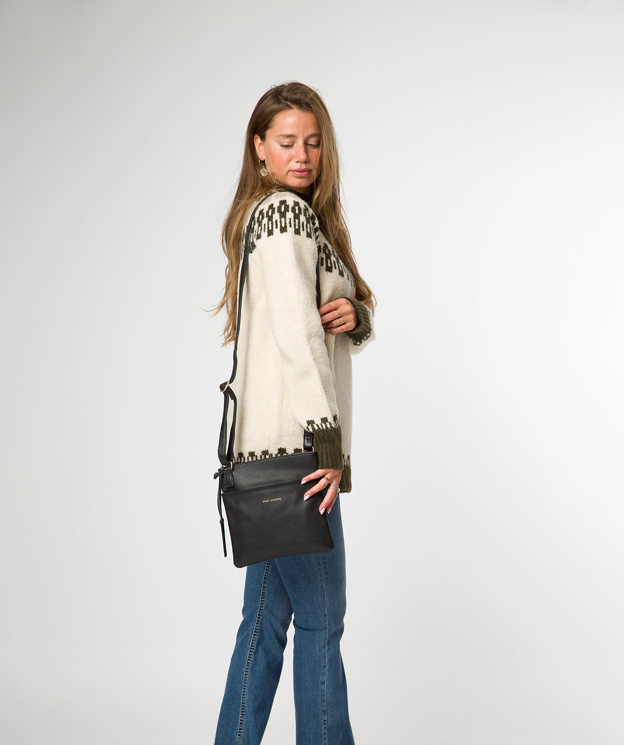 Nola crossbody bag side profile with embossed logo