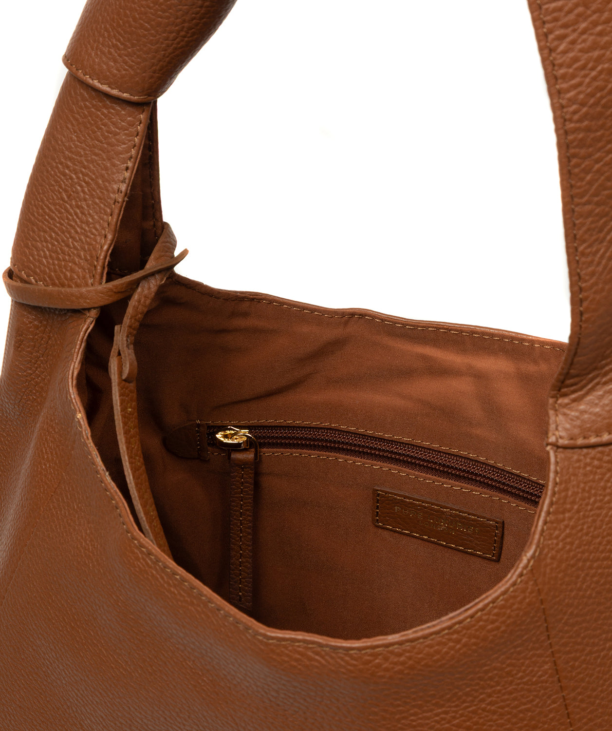 Close-up of gold foil Pure Luxuries logo on tan leather