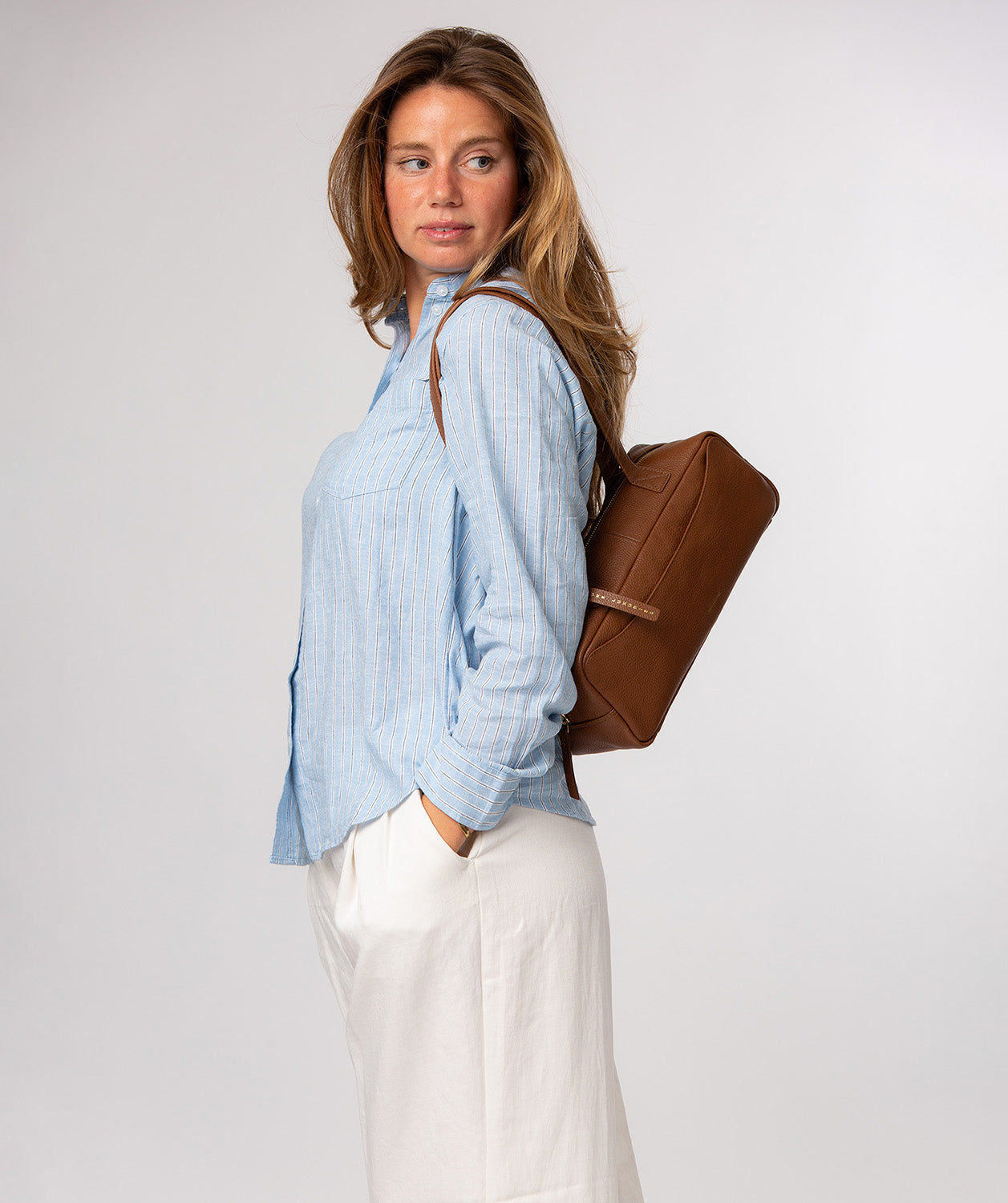 Rear slip pocket detail on tan leather handbag