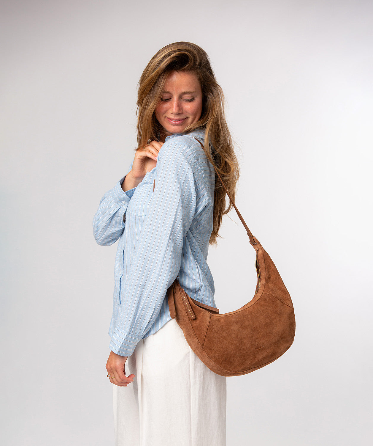 Back view of tan suede bag with embossed logo