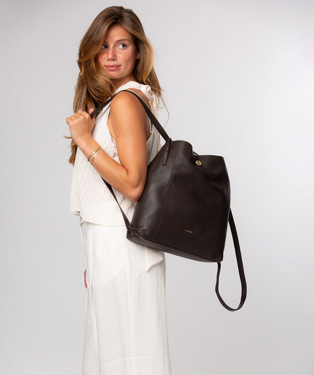 backpack worn as shoulder bag with adjustable straps