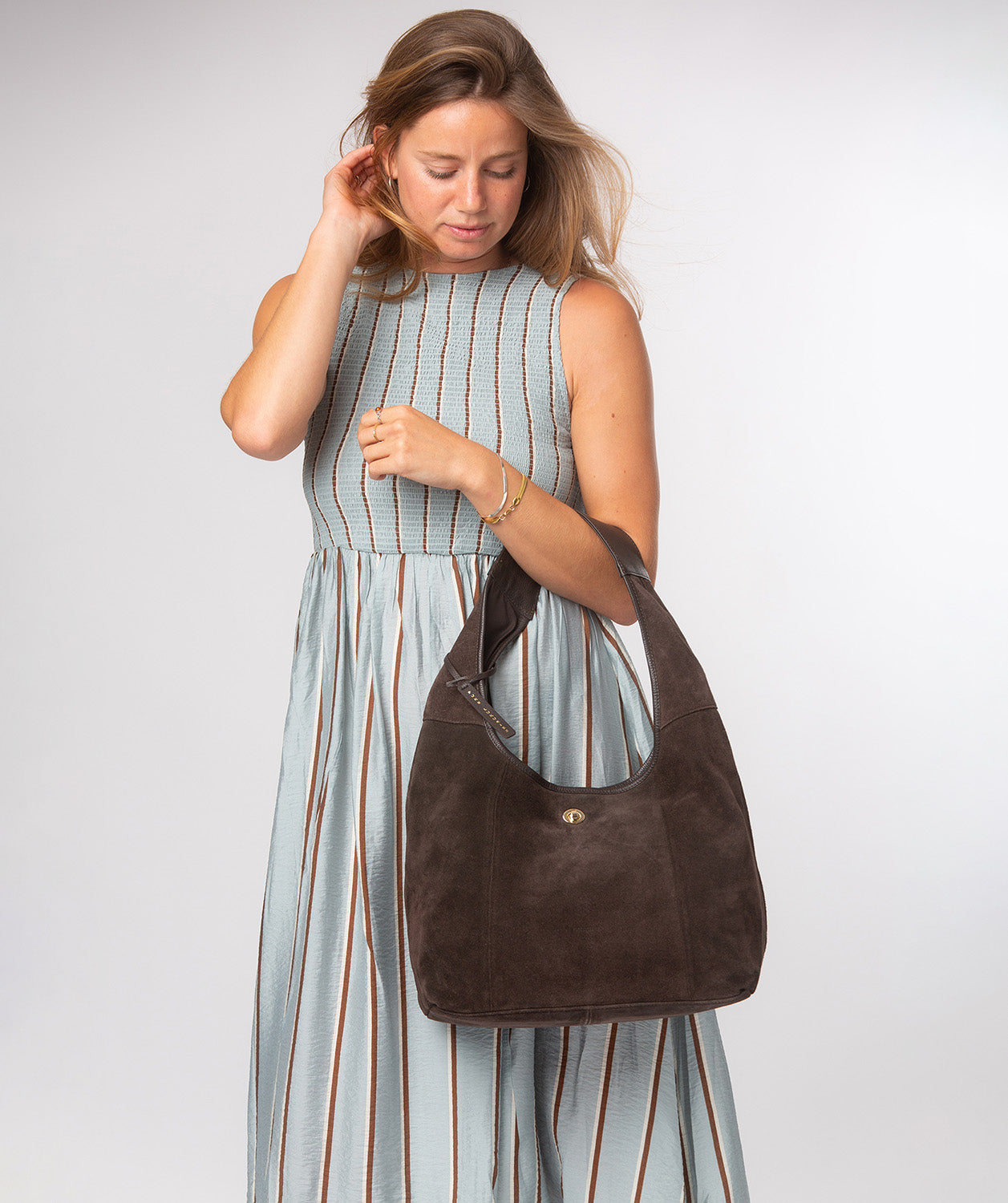 Espresso suede Polly bag worn on shoulder