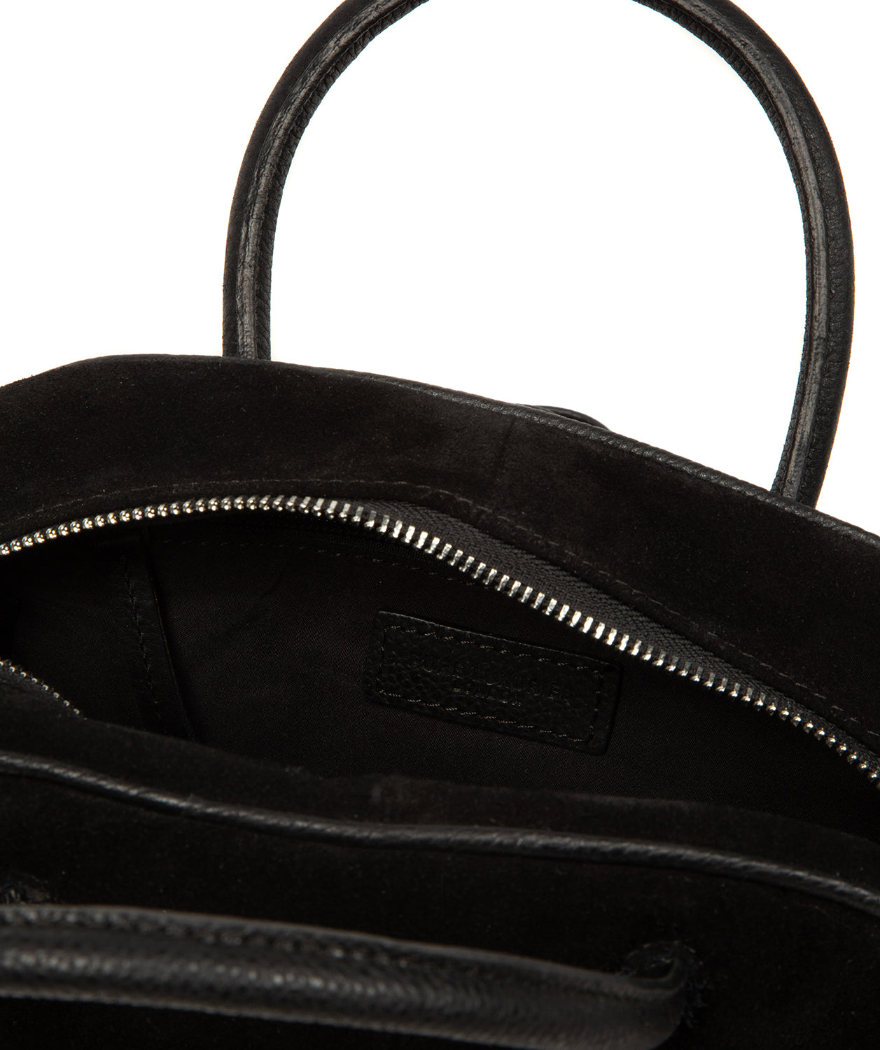 Interior zipped pocket and soft lining of black suede bag