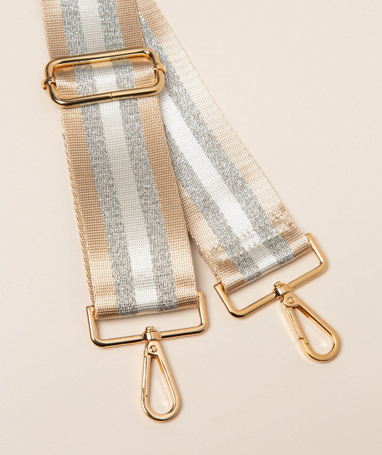 Pure Luxuries champagne silver striped canvas bag strap with gold fittings front view