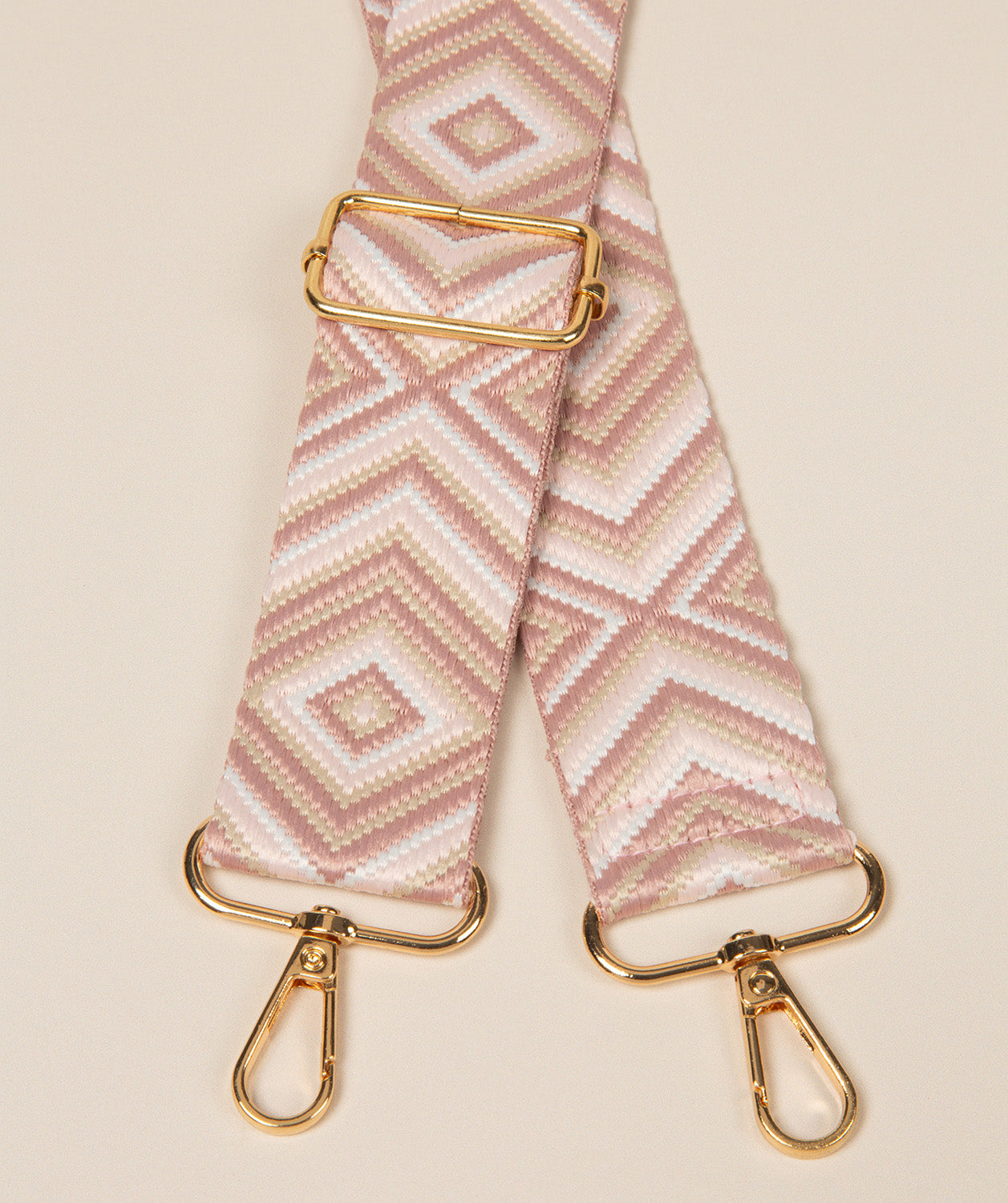 Pure Luxuries dusty pink geometric mix bag strap with gold fittings front view