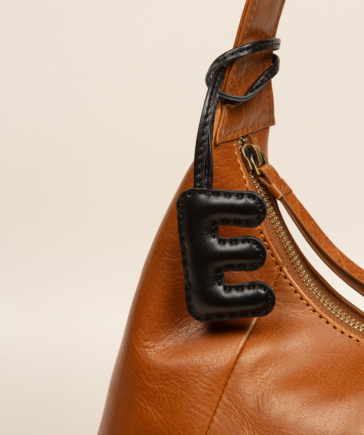leather letter charm showing smooth natural finish