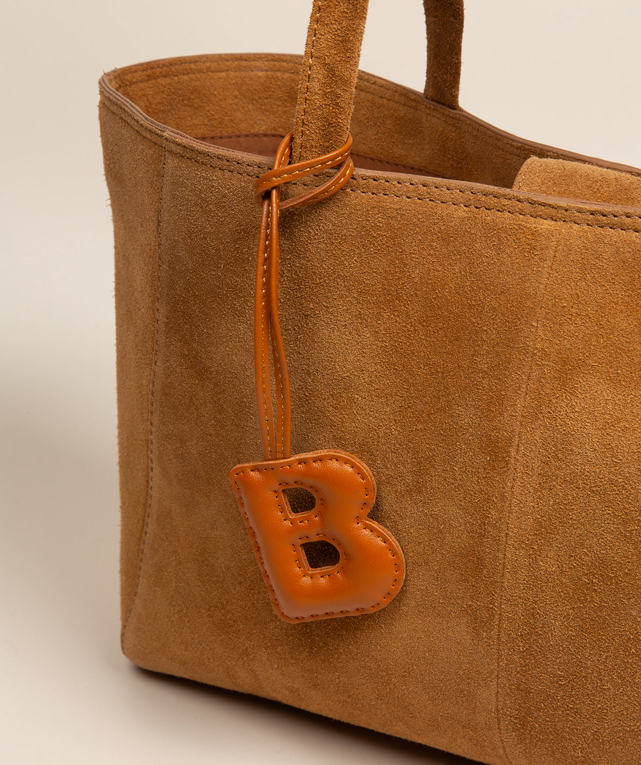 tan leather charm demonstrating soft pillow-like filling
