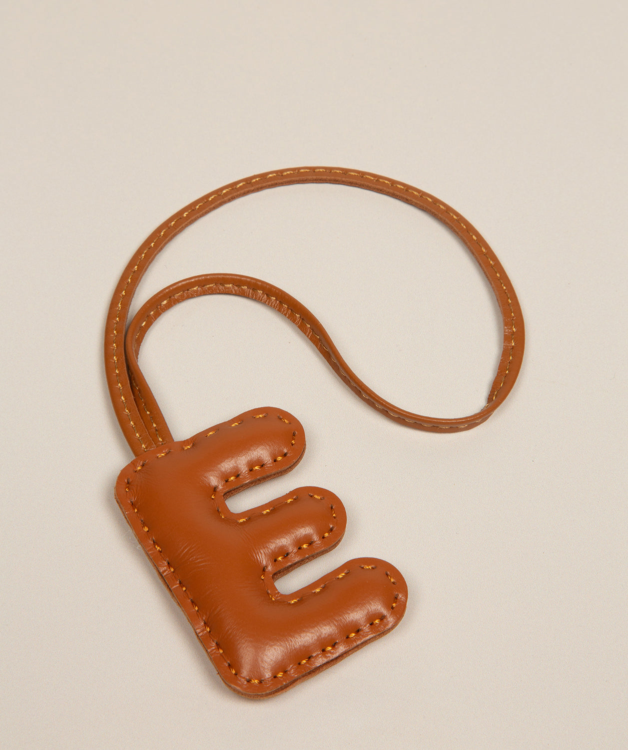 tan leather charm personalised letter accessory