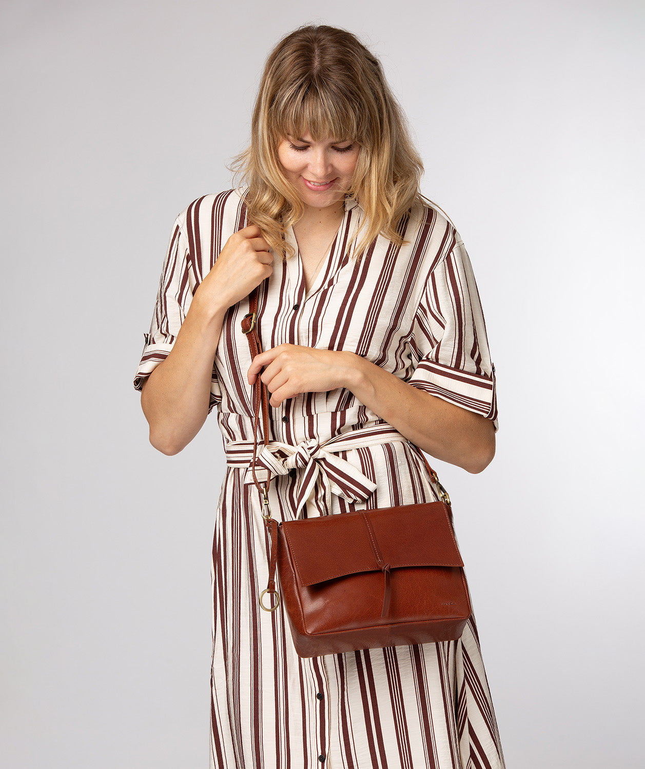 fold-over magnetic closure and tied tassel detail