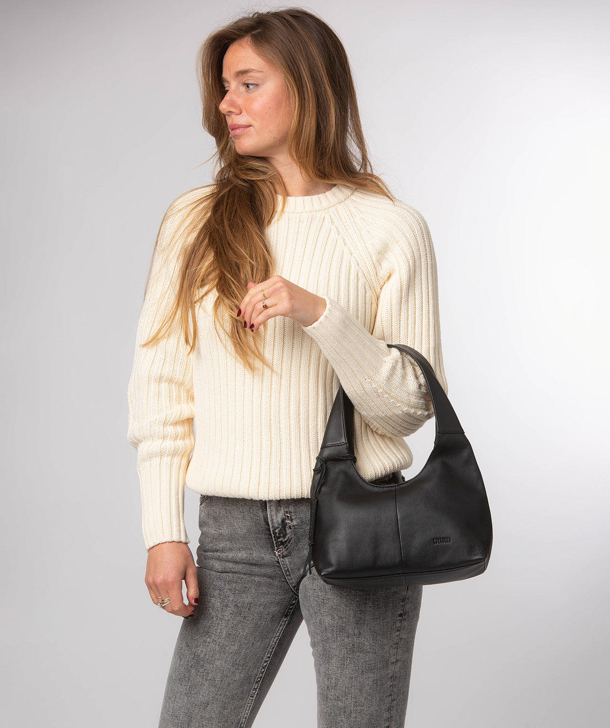 Black leather grab bag with decorative hanging charm