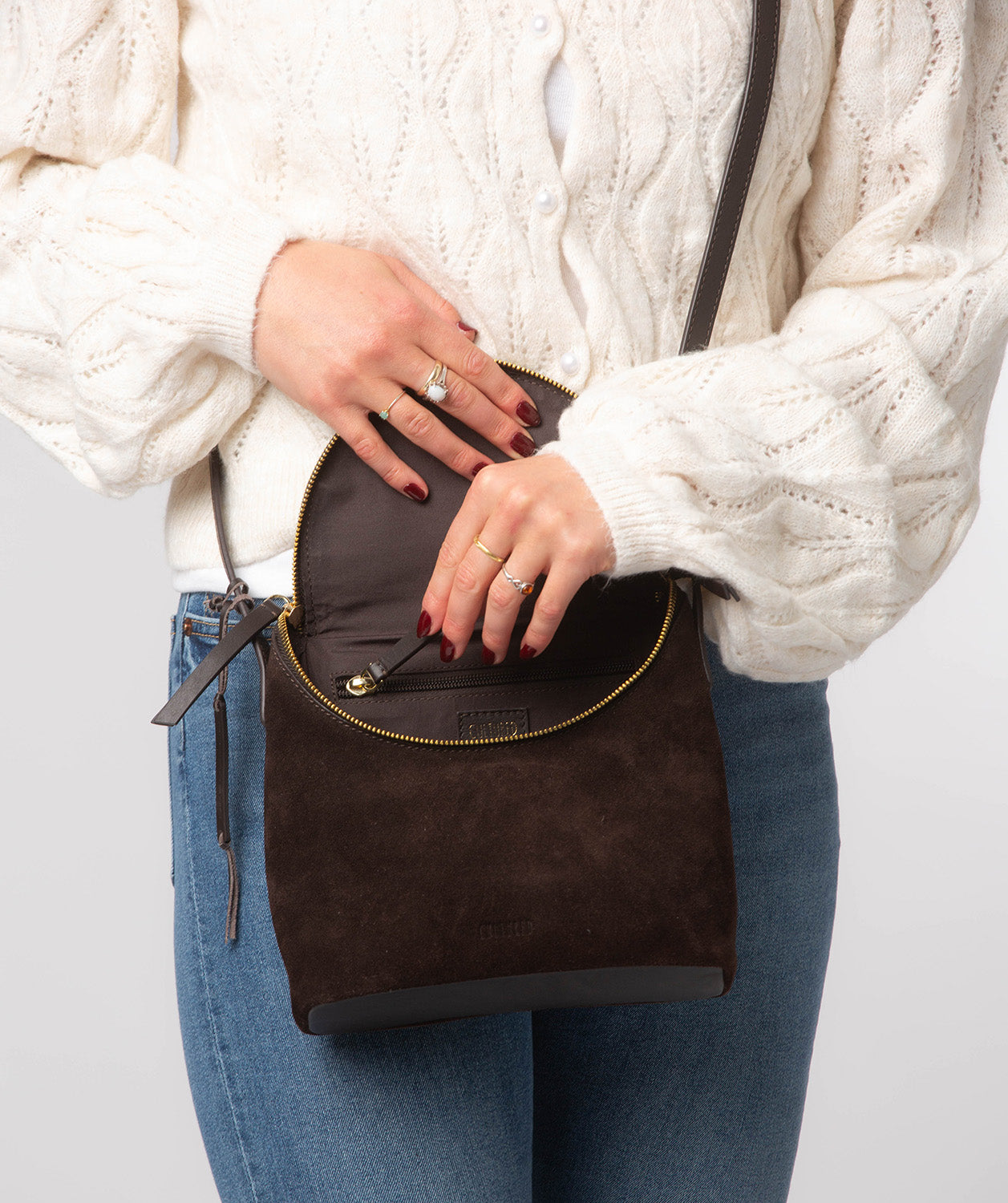 Crossbody bag worn across body showing drop length