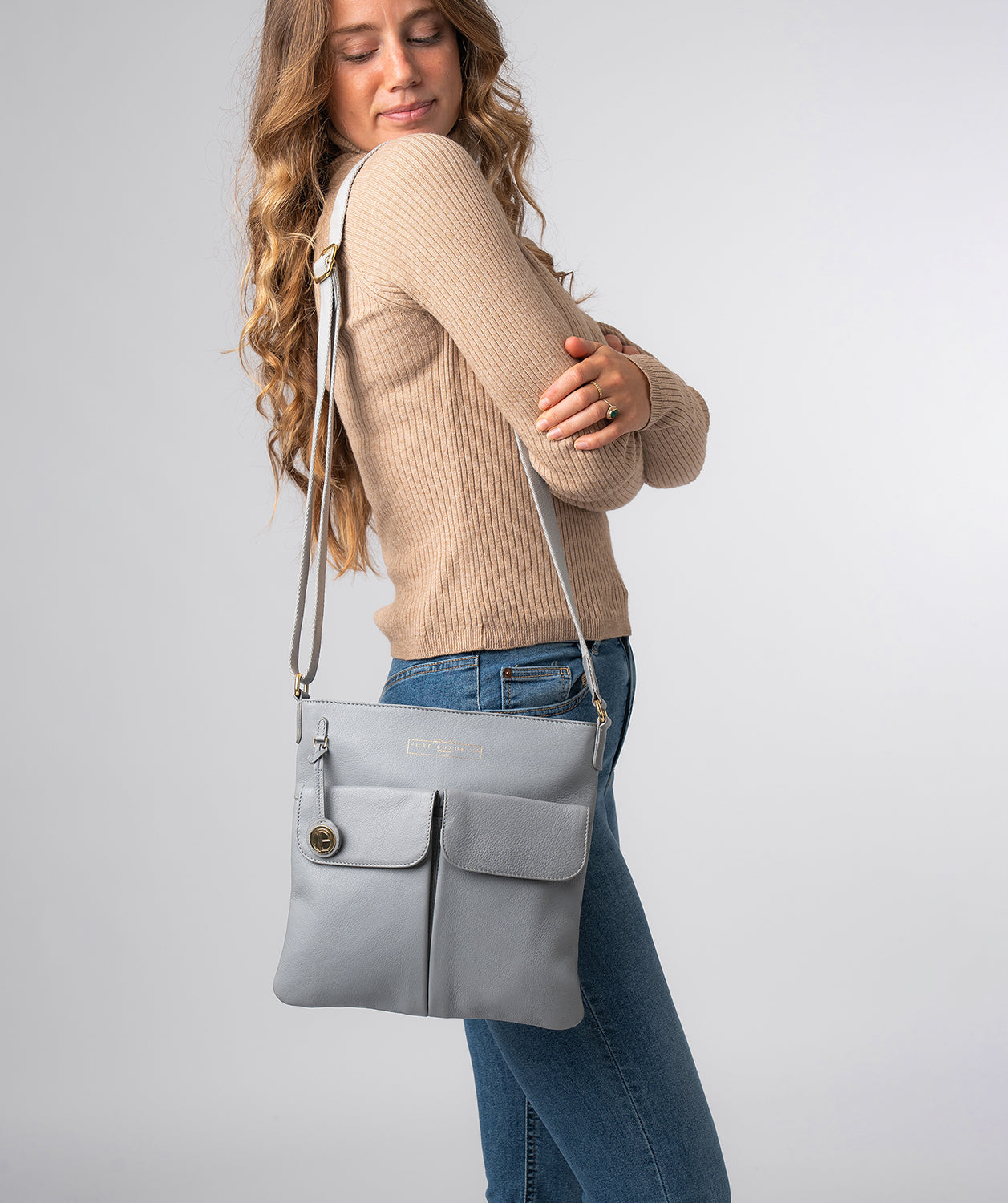 Grey leather crossbody bag detail showing fine grain texture