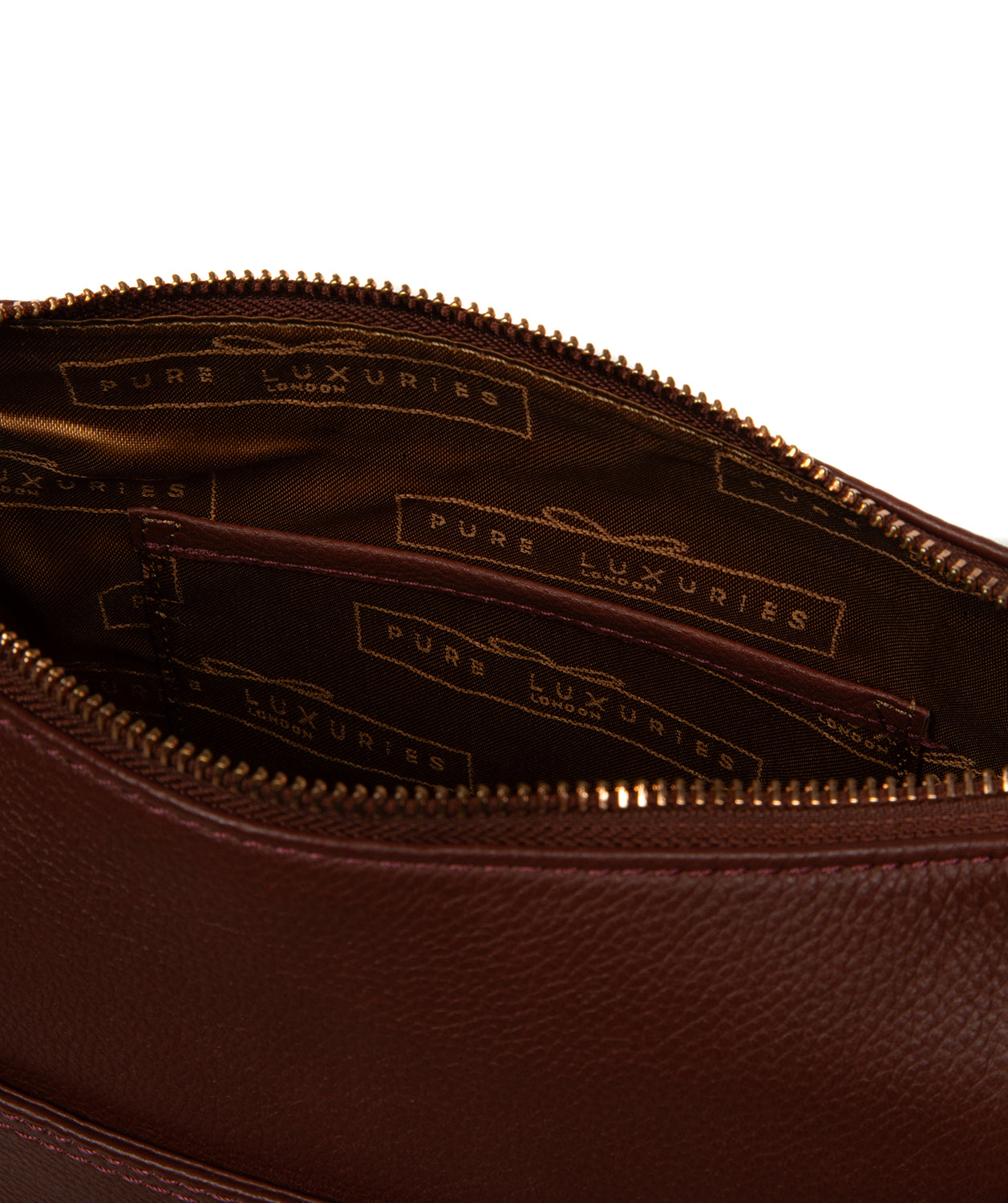 Close-up of embossed Pure Luxuries logo and rose gold fittings
