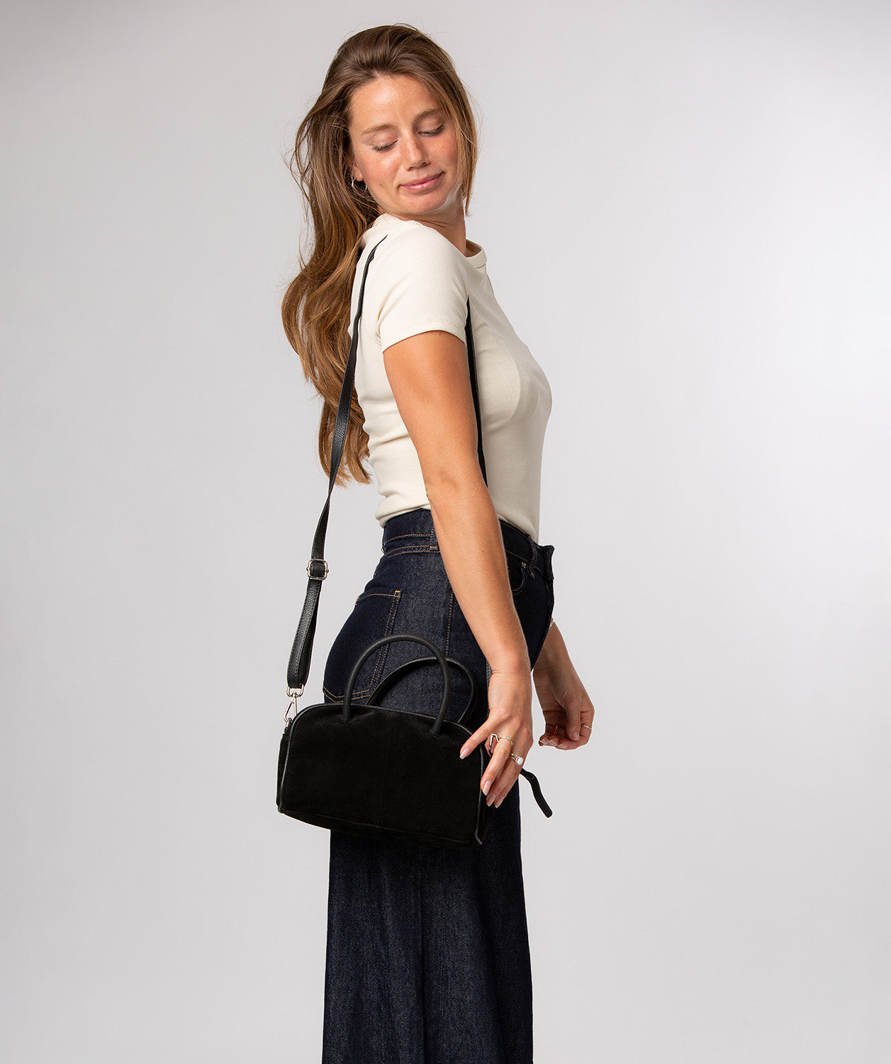 Faith mini bag showing rounded dual handles and handheld carry