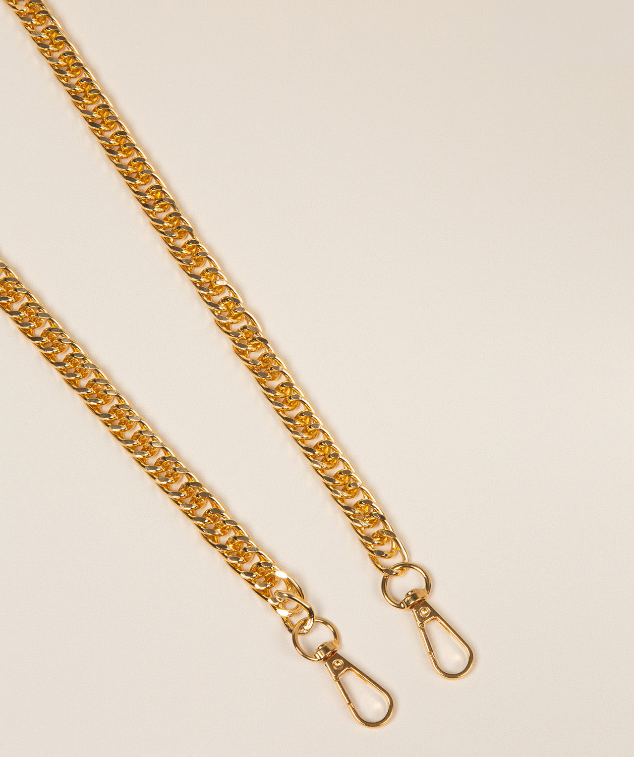 Pure Luxuries gold flat curb chain strap full length view