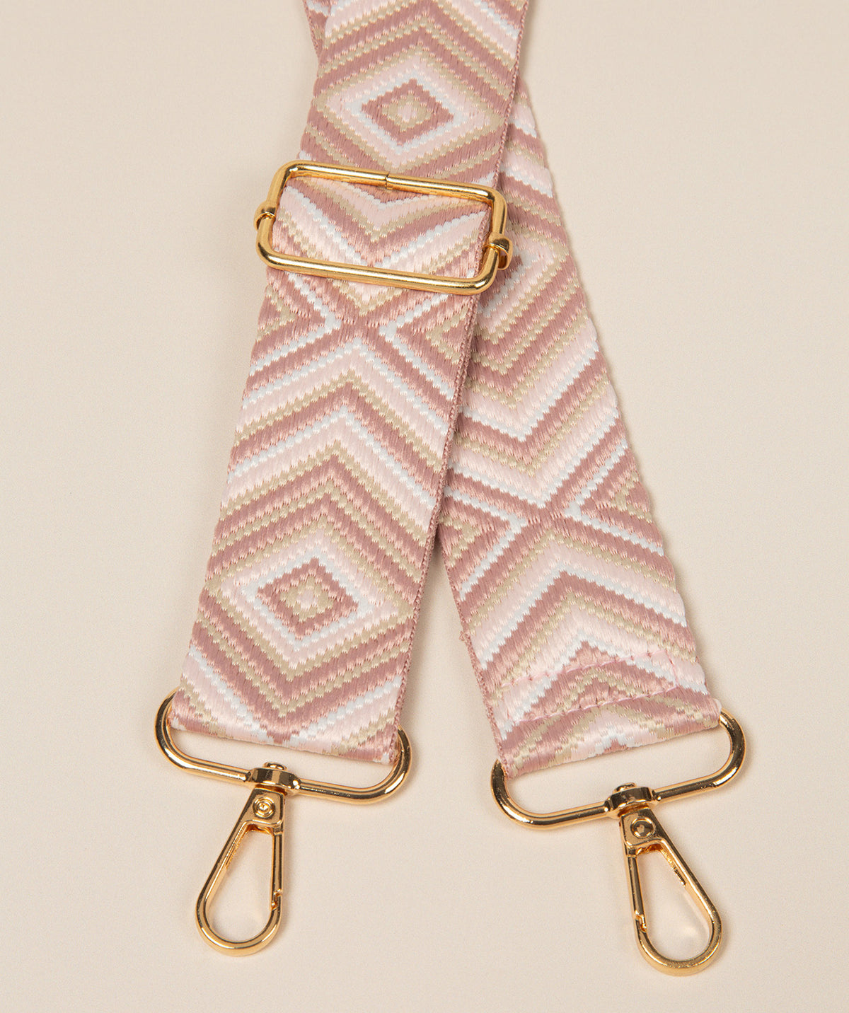 Pure Luxuries dusty pink geometric mix bag strap with gold fittings front view