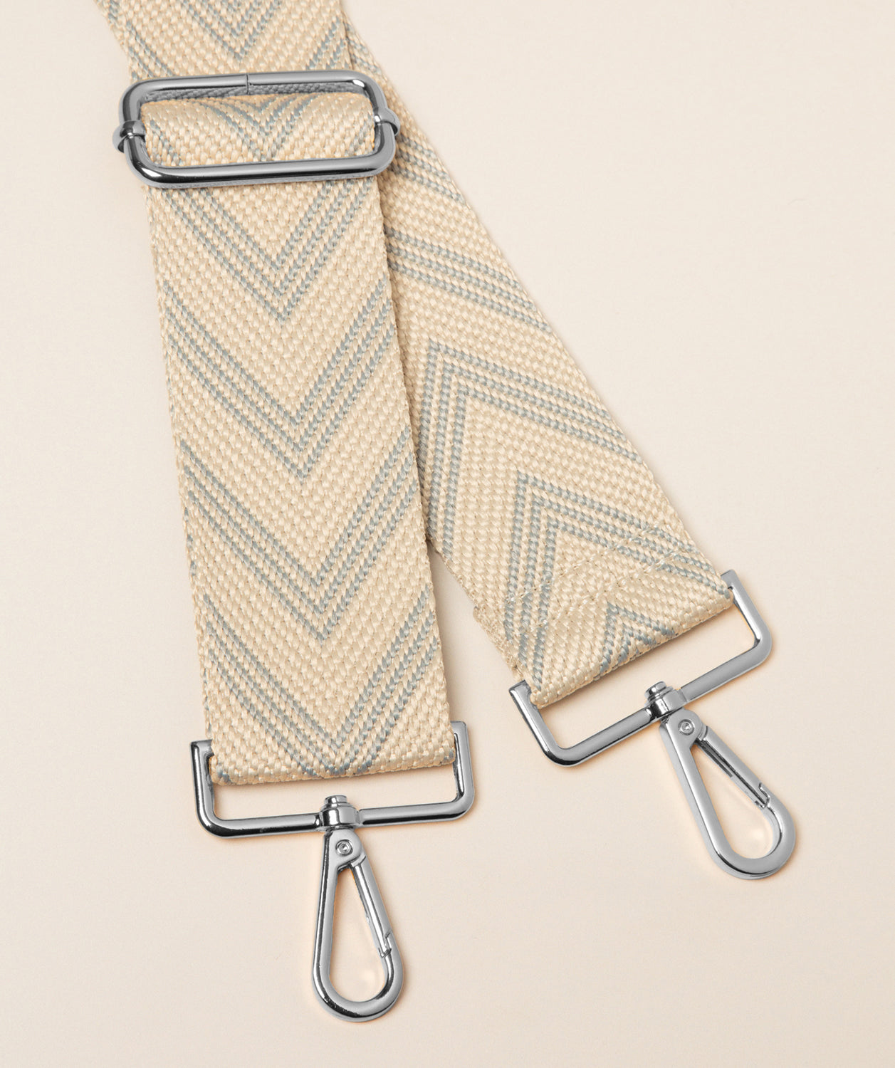 Pure Luxuries grey and cream canvas chevron bag strap with silver fittings front view